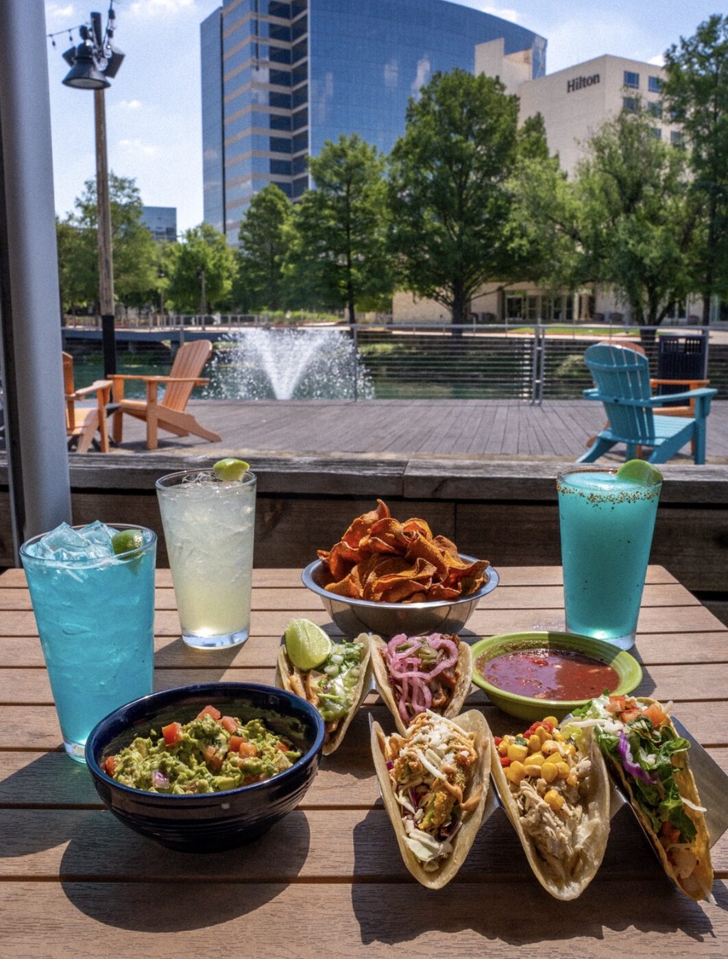 Blue Mesa Grill patio spread with margaritas and tacos