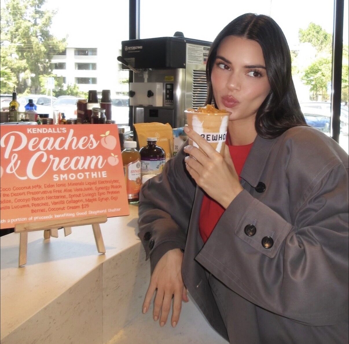 Kendall Jenner holding the Erewhon x Lily of the Desert Peaches and Cream smoothie