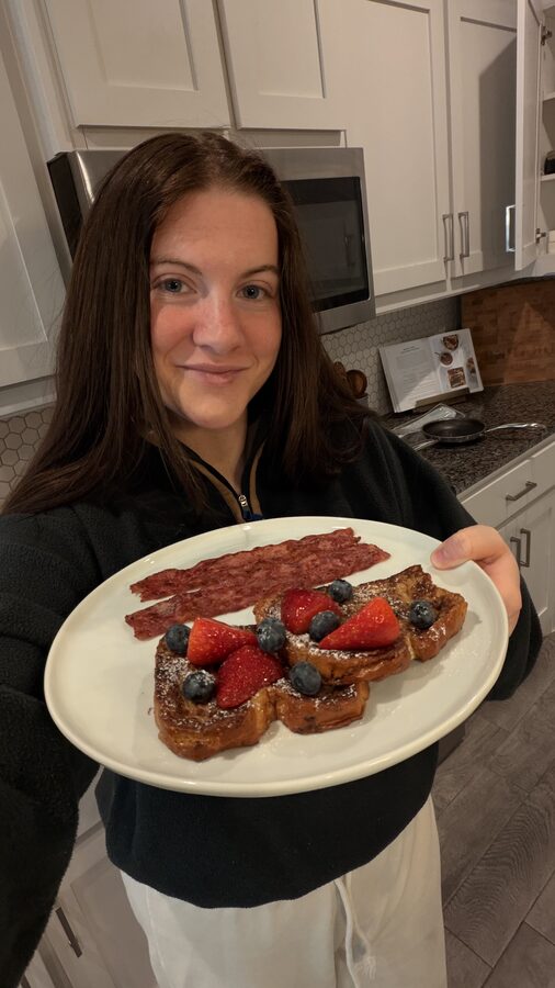 Selfie holding a plate of French toast and bacon